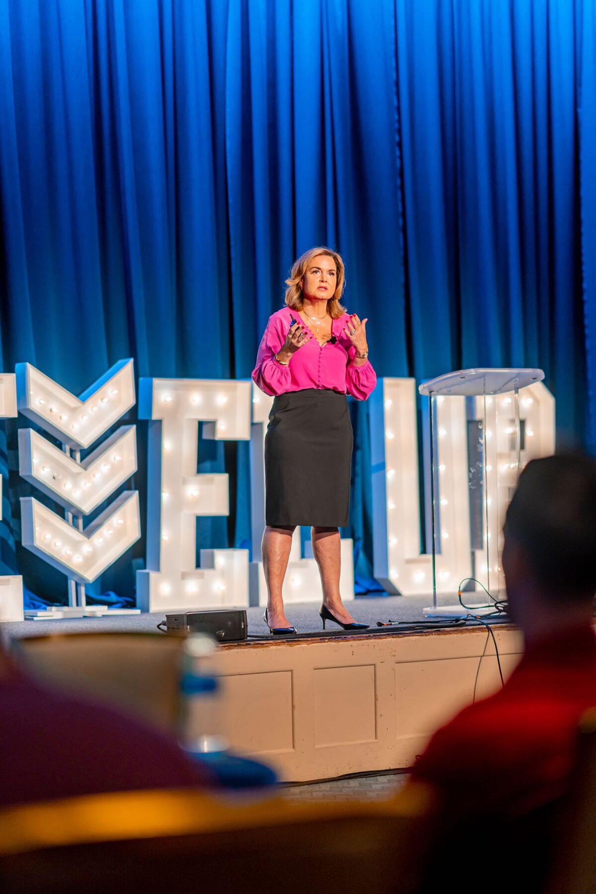 Debra speaking on a main stage